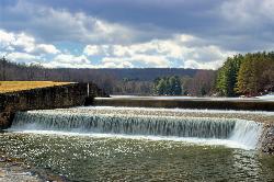 Water pouring over the native sandstone dam the Civilian Conservation Corps built in the 1930s on th courtesy of Nicholas A. Tonelli&nearr; (CC BY 2.0&nearr;)