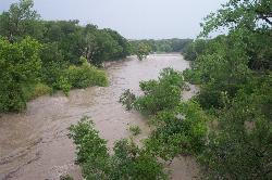 The South San Gabriel River in flood at Blue Hole Park, July 2002. courtesy of Ahodges7&nearr; (CC BY-SA 3.0&nearr;)