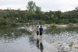 Swimmers and waders on the low dam at Blue Hole Park on the South San Gabriel River. courtesy of Carol M. Highsmith&nearr; (Public domain&nearr;)