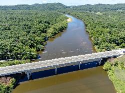 The Black River from the air, running tea-brown past sandbars and wooded bluffs. courtesy of Wikideas1&nearr; (CC0&nearr;)