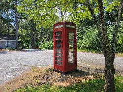 A red telephone box repurposed as a little free library in Pine Lake courtesy of John Phelan&nearr; (CC BY 4.0&nearr;)