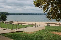 Handrails and paved walkway leading down to the sand from the grass slope above the beach. courtesy of Virginia State Parks staff&nearr; (CC BY 2.0&nearr;)