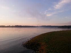 Morning mist over the swim area, buoys and marker posts strung across the shallow shelf courtesy of Augustin Liviu&nearr; (CC BY-SA 3.0&nearr;)