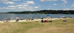 Swimmers inside the buoyed area on a summer afternoon at the state park beach courtesy of Tomwsulcer&nearr; (CC0&nearr;)