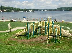 One of the park's two playgrounds, set on the lawn just above the sand courtesy of Tomwsulcer&nearr; (CC0&nearr;)