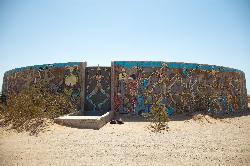 A mural-covered concrete water tank ruin left over from the World War II Camp Dunlap base at Slab Ci courtesy of Diarrhea&nearr; (CC BY 3.0&nearr;)