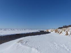 Where the channel meets Lake Michigan, with the big lake iced over in February. courtesy of John Winkelman&nearr; (CC BY 2.0&nearr;)