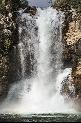 Spring snowmelt thundering over the upper lip of Running Eagle Falls courtesy of GlacierNPS&nearr; (Public domain&nearr;)