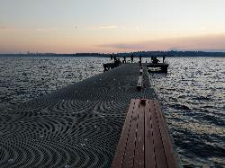 Walking out the Waverly Beach Park dock toward anglers fishing at the far end courtesy of clocky&nearr; (CC BY-SA 4.0&nearr;)