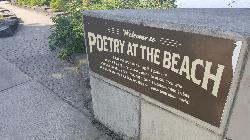 The Poetry at the Beach marker at the top of the stone-lined path courtesy of Another Believer&nearr; (CC BY-SA 4.0&nearr;)