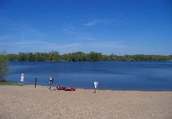 A quiet Cedar Lake beach with the lifeguard stand still empty. courtesy of AlexiusHoratius&nearr; (CC BY-SA 3.0&nearr;)