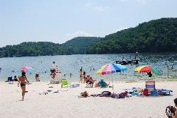 A lifeguard on the stand at the guarded beach on a summer afternoon courtesy of Virginia State Parks staff&nearr; (CC BY 2.0&nearr;)