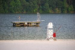 The offshore swim platform with its ladder and diving board, and a lifeguard chair at the waterline  courtesy of Virginia State Parks staff&nearr; (CC BY 2.0&nearr;)