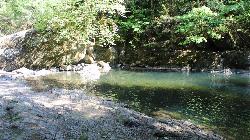 Shallow bedrock along the near edge of the swimming hole. courtesy of Bureau of Land Management Oregon and Washington&nearr; (Public domain&nearr;)