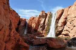 The lower Gunlock Falls spillway dropping through red sandstone below the dam courtesy of Panaram 