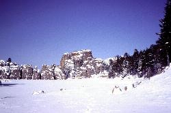 Sylvan Lake in winter, showing the Precambrian granite that forms its rim. courtesy of Dexter Perkins&nearr; (CC0&nearr;)