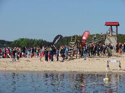 An open water swim start on the beach, with the park sign reading no swimming when no lifeguard is o courtesy of Virginia State Parks&nearr; (CC BY 2.0&nearr;)