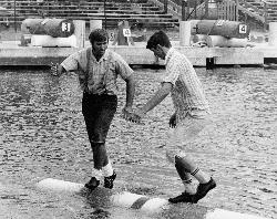 Logrolling at the Lumberjack World Championships in the Lumberjack Bowl, a bay of Lake Hayward just  courtesy of Guywelch2000&nearr; (CC BY-SA 4.0&nearr;)