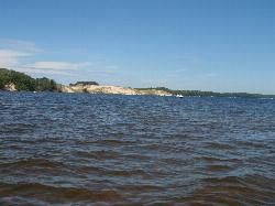 Open dunes across the water on the Hamlin Lake side of the park, the warmer and calmer swimming opti courtesy of Drag N Ballz&nearr; (Public domain&nearr;)