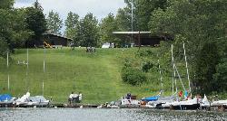 Small boats, docks and a grassy launch slope at the Cowan Lake Sailing Association. courtesy of R S Tsuchiya&nearr; (CC BY-SA 3.0&nearr;)