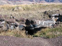 Close view of the basalt rim and handrail at the Niter Ice Cave entrance courtesy of Unknown authorUnknown author or not provided&nearr; (Public domain&nearr;)