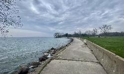 The concrete lakefront walkway near Area 1 on a rainy spring day in 2022 courtesy of Andre Carrotflower&nearr; (CC BY-SA 4.0&nearr;)