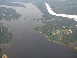 Aerial view of Jordan Lake's wooded shoreline and a highway bridge crossing the reservoir courtesy of Mx. Granger&nearr; (CC0&nearr;)