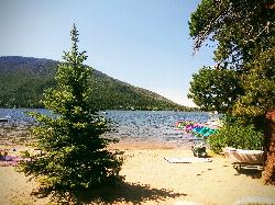 Sandy beach on the north shore of Grand Lake on a summer afternoon courtesy of Faith Warehime&nearr; (CC BY-SA 4.0&nearr;)