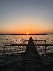 A pier on Lake Monona at Stone Bridge Park in the City of Monona at sunset. Photo by Alexsuchy, CC B