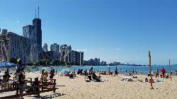 A busy afternoon at Ohio Street Beach, with umbrellas, swimmers and the Hancock Center in the distan courtesy of Joe Passe&nearr; (CC BY-SA 2.0&nearr;)