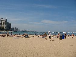 Beachgoers on the sand and in the water at Ohio Street Beach. courtesy of My_Core_Competency_is_Competency (talk) (Uploads)&nearr; (CC BY-SA 3.0&nearr;)