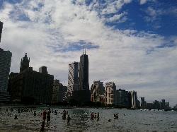Swimmers wading in Lake Michigan off Ohio Street Beach, with the downtown skyline behind them. courtesy of Caitriana Nicholson from 北京 ~ Beijing, 中国 ~ China&nearr; (CC BY-SA 2.0&nearr;)