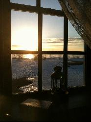 Winter sunrise over the water seen from the lighthouse keeper's quarters at Tawas Point. courtesy of GLSGMC&nearr; (CC BY-SA 4.0&nearr;)