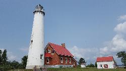 The Tawas Point Light Station tower, keeper's house and outbuilding on the park grounds. courtesy of Johnkan0301&nearr; (CC BY-SA 4.0&nearr;)