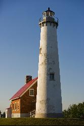 Close view of the Tawas Point Lighthouse tower in evening light. courtesy of Dyarnall&nearr; (CC BY-SA 3.0&nearr;)