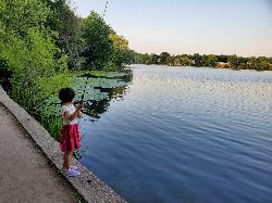 Fishing from the stone shore wall of Crystal Lake on a summer evening. courtesy of NewtonCourt&nearr; (CC BY-SA 4.0&nearr;)