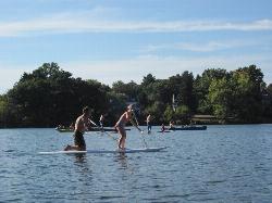 Paddleboarders and canoes on Crystal Lake on a clear September day. courtesy of NewtonCourt&nearr; (CC BY-SA 4.0&nearr;)