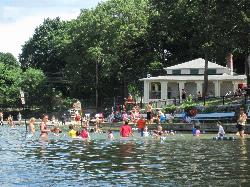 Swimmers in the guarded swim area in front of the Crystal Lake bathhouse. courtesy of NewtonCourt&nearr; (CC BY-SA 4.0&nearr;)