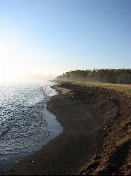 The Lake Superior shoreline running southwest from the park, with an eroded stamp sand bank above th courtesy of Chuck Ritola&nearr; (CC BY-SA 3.0&nearr;)