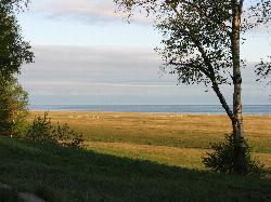 Lake Superior seen across the park's grassy upland on a summer morning. courtesy of Chuck Ritola&nearr; (CC BY-SA 3.0&nearr;)