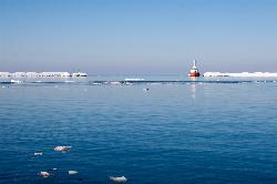 Early spring ice breaking up on the water between the breakwaters at the north entry. courtesy of Robert Emperley&nearr; (CC BY-SA 2.0&nearr;)