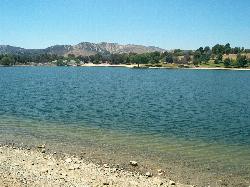 Castaic Lagoon from a gravel stretch of shoreline, with sandy beach and picnic grounds on the far sh courtesy of Summit Hopper&nearr; (CC BY 2.0&nearr;)