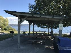Picnic Shelter 2 on the lawn beside the swim beach, with the swim platform offshore. courtesy of Seattle Parks & Recreation&nearr; (CC BY 2.0&nearr;)
