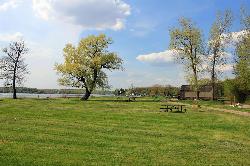Picnic lawn and tables at Big Foot Beach State Park with Geneva Lake beyond the trees. courtesy of Yinan Chen&nearr; (Public Domain&nearr;)