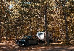 A campsite under red pines at McCarthy Beach State Park. courtesy of Tony Webster&nearr; (CC BY 2.0&nearr;)