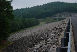 The rock-faced earthen dam that holds back Surry Mountain Lake. courtesy of Talus.rock&nearr; (CC BY-SA 4.0&nearr;)