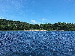 Cox Hollow Lake Beach and the bathhouse seen from out on the lake. courtesy of Heidi Meudt&nearr; (CC BY 4.0&nearr;)