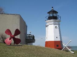 The lighthouse and lakefront lawn at Main Street Beach & Park in early spring. courtesy of Dougtone&nearr; (CC BY-SA 2.0&nearr;)