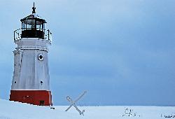 The Vermilion Lighthouse in winter with snow over the beach and frozen lake. courtesy of Rona Proudfoot from Lorain, Ohio&nearr; (CC BY-SA 2.0&nearr;)