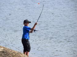 A boy wading off a granite ledge into Hensley Lake. courtesy of U.S. Army Corps of Engineers Sacramento District&nearr; (Public domain&nearr;)